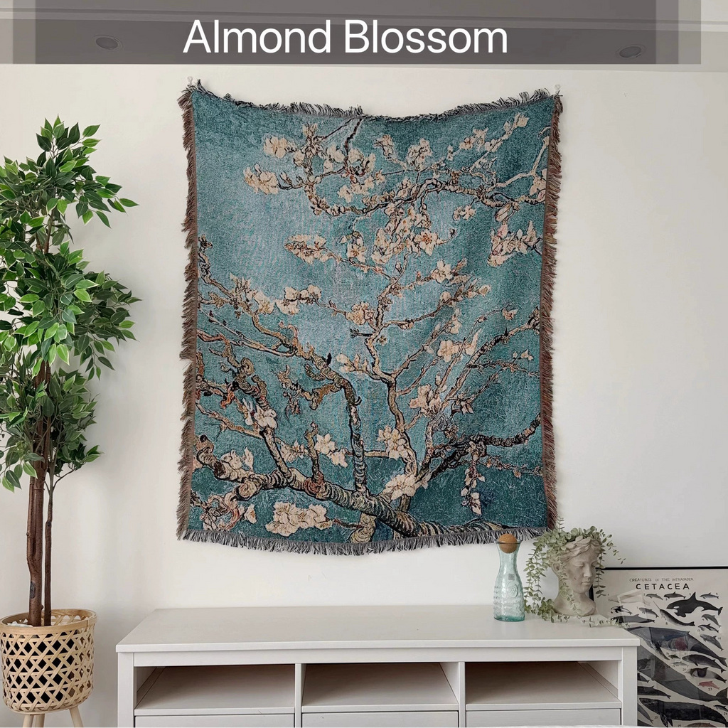 Wall tapestry with floral design labeled 'Almond Blossom' in a room setting.